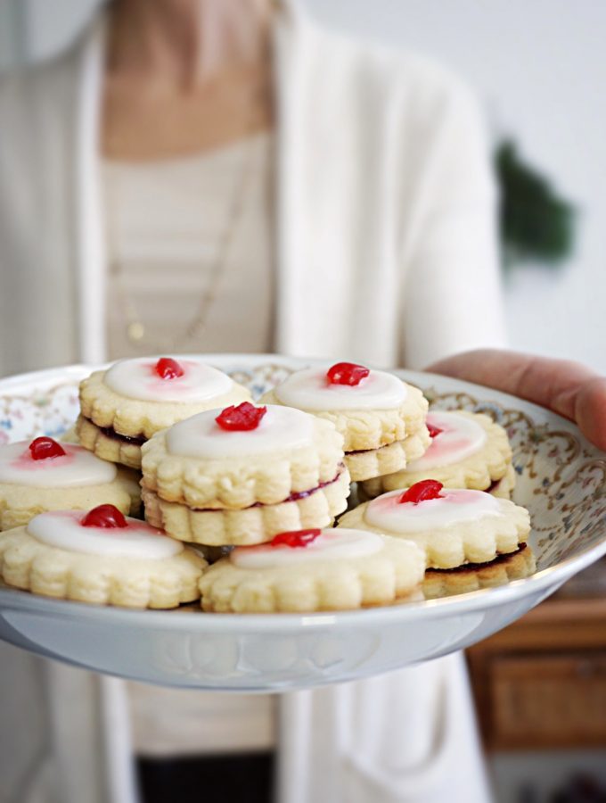 Classic Empire Cookies for the Holiday. Filled with raspberry jam, toped with almond icing and a cherry on top!