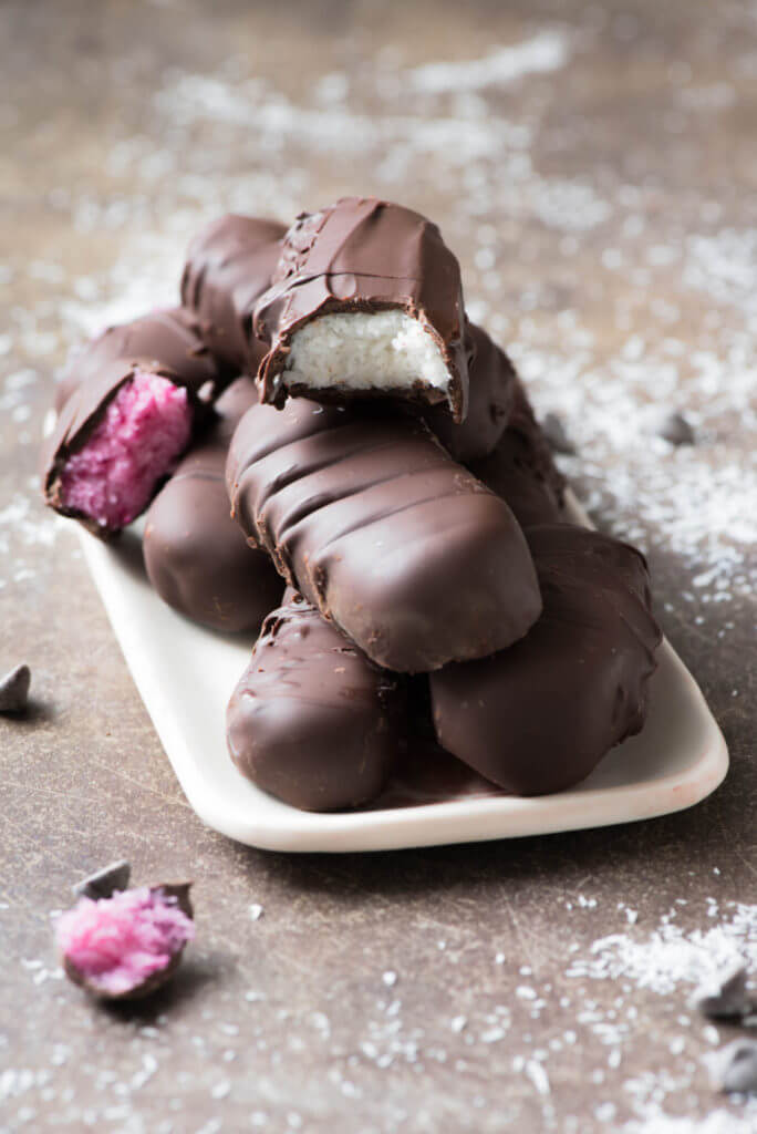 Decadent chocolate covered coconut bars aka Bounty bars that are healthy, free of priority allergens, paleo, naturally colored and naturally sweetened. 