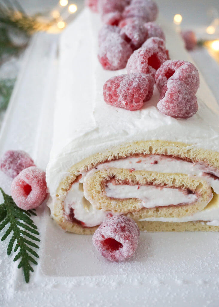 A simple and impressive Festive Holiday Jelly roll made with E.D. Smith Fruit Spread, cognac and topped with sugared raspberries.