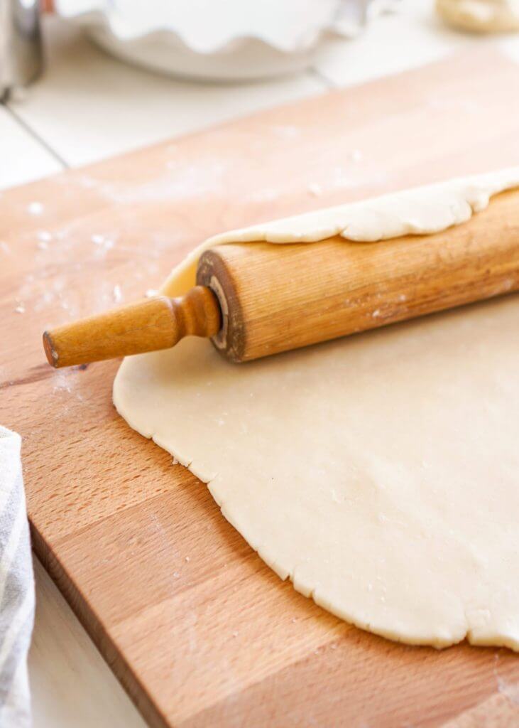 Rolling the dough back onto your rolling pin to pick the pastry up and to place into your pie dish